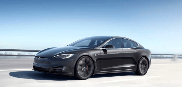 Black Tesla model driving along the road