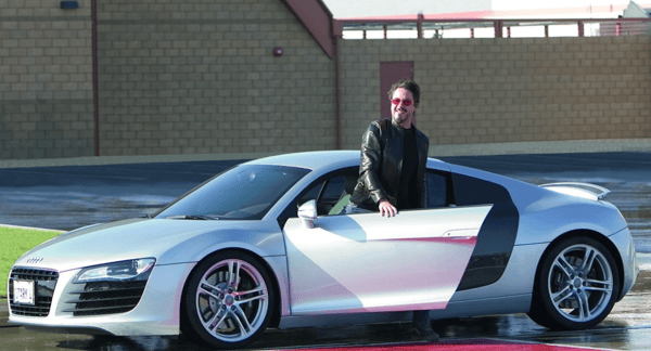 Tony Star getting out of his silver Audi R8