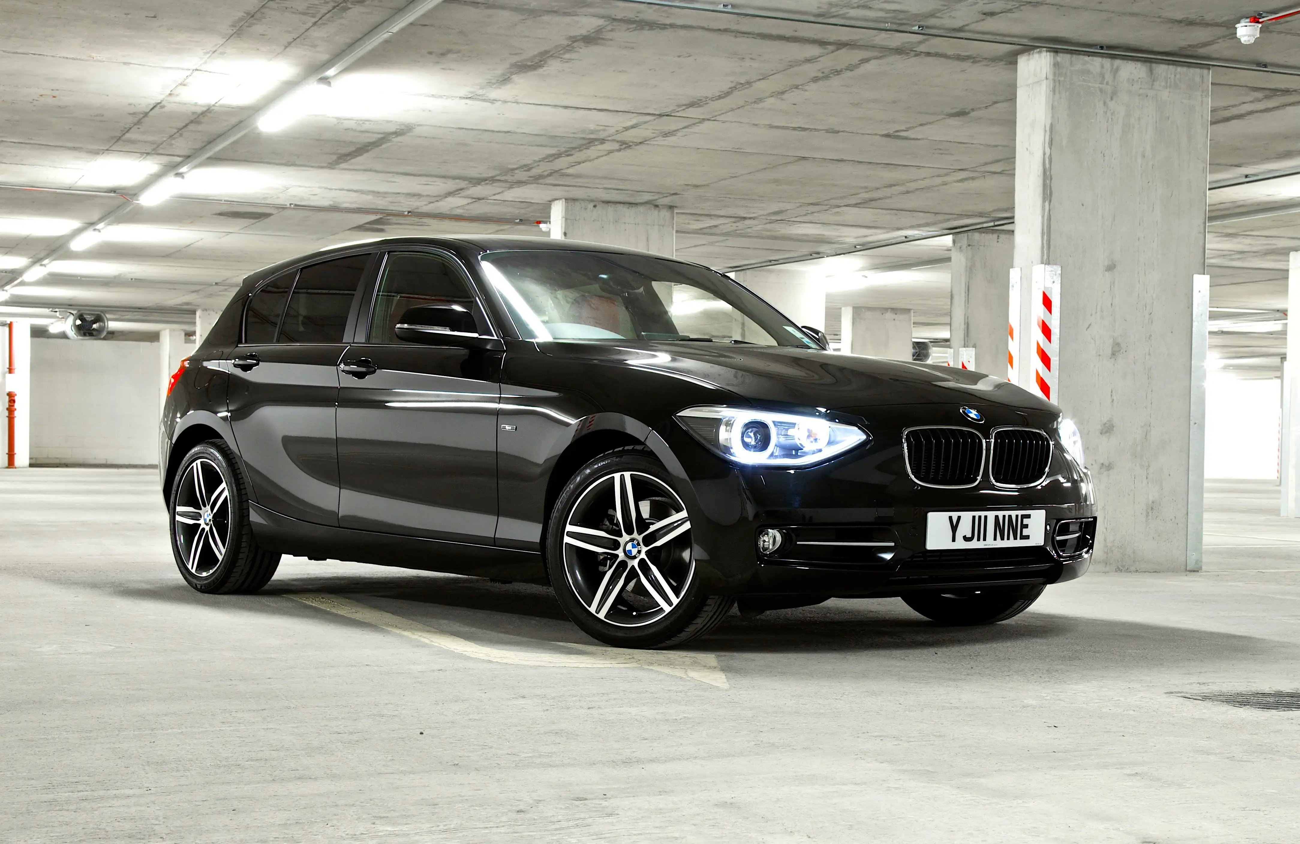 black-BMW-1-Series-parked-side