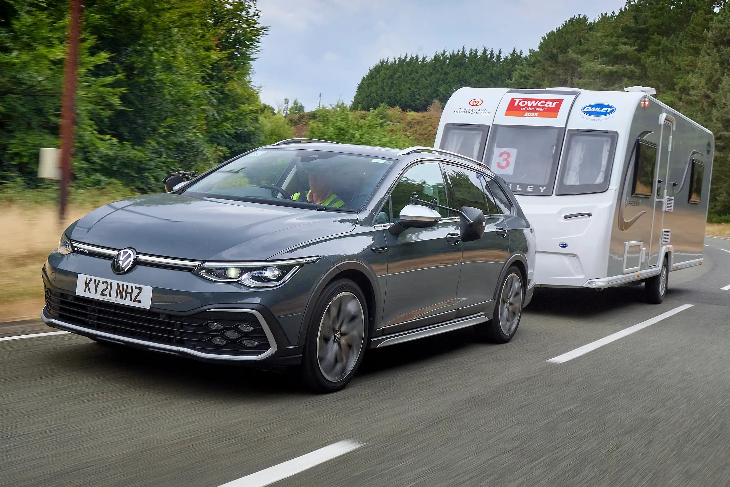 black-Volkswagen-Golf-Estate-dynamic-with-camper