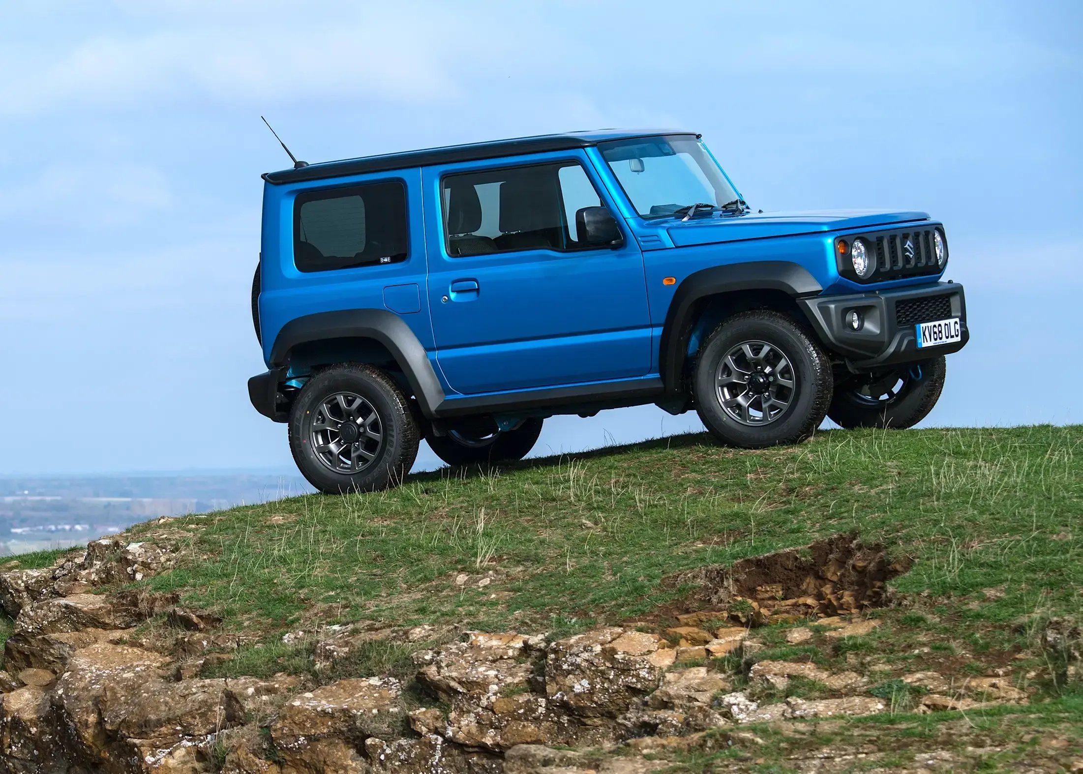 blue-Suzuki-Jimny-parked-side