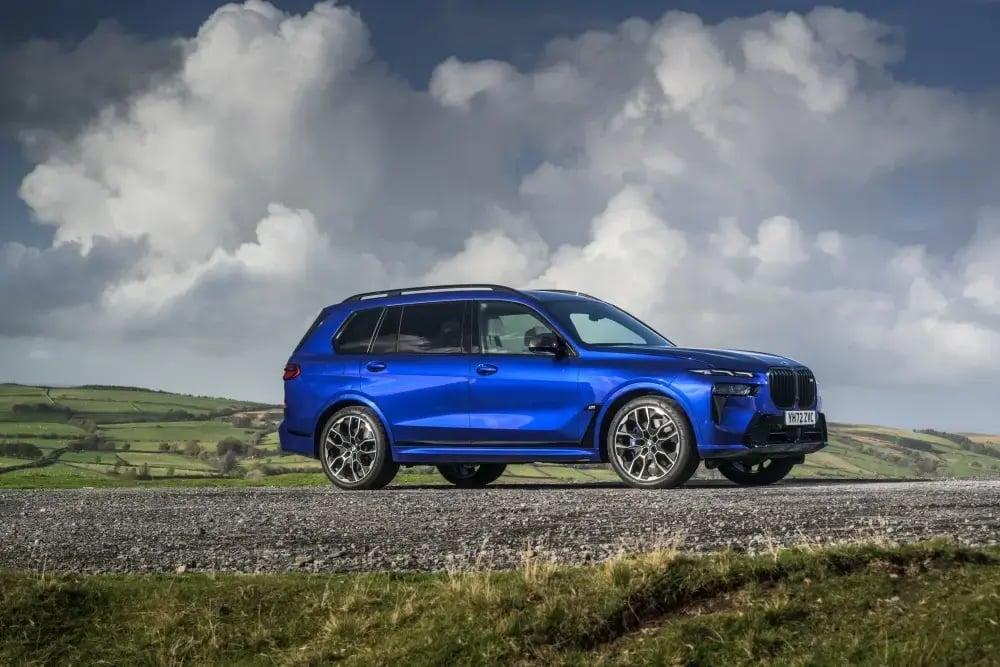 blue-bmw-x7-large-suv-side-parked