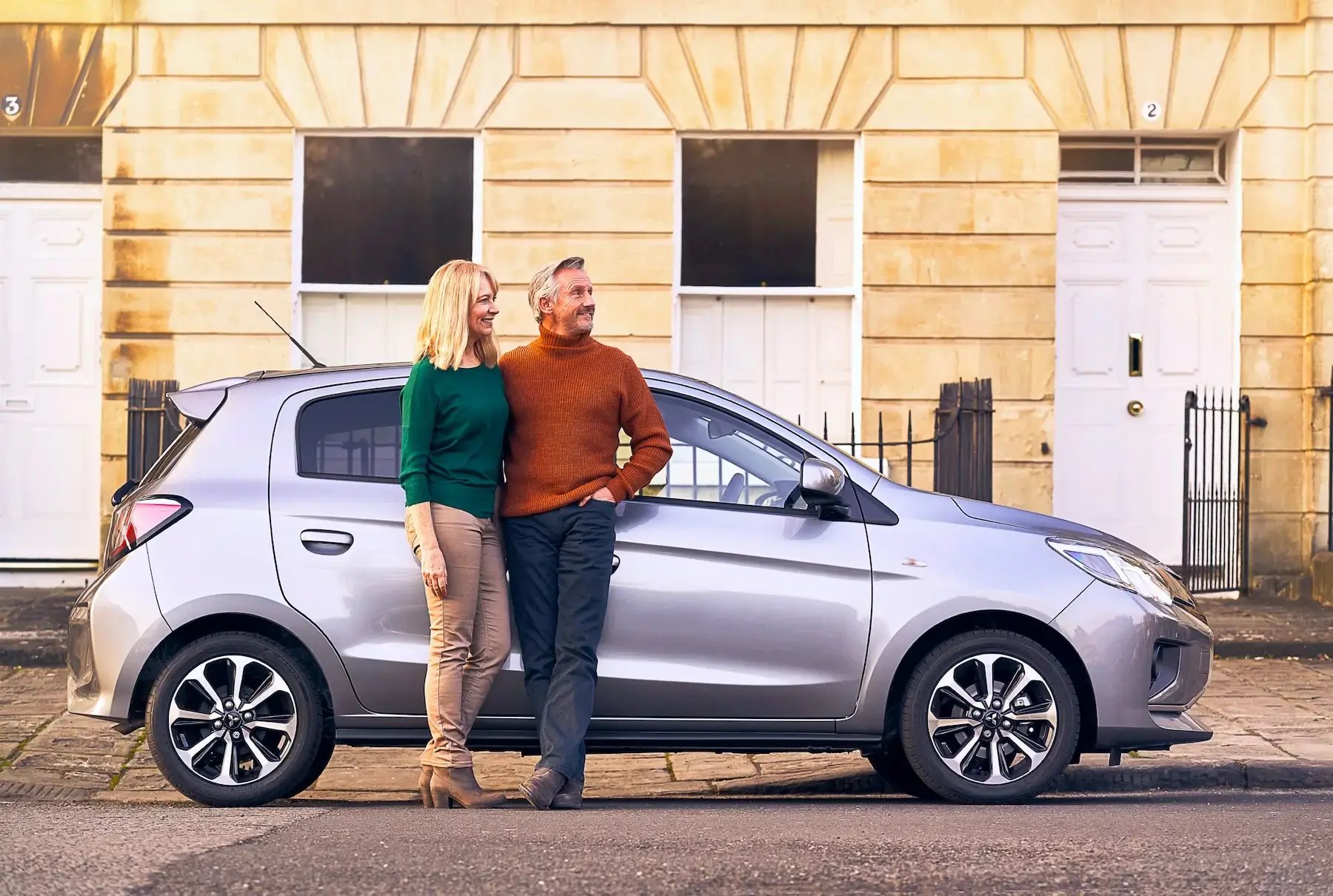 couple-standing-beside-car