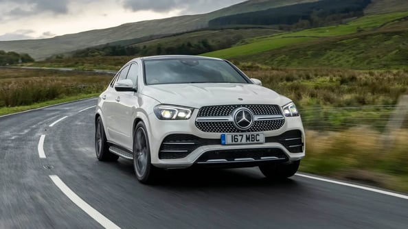 White Mercedes Benz GLE on country road