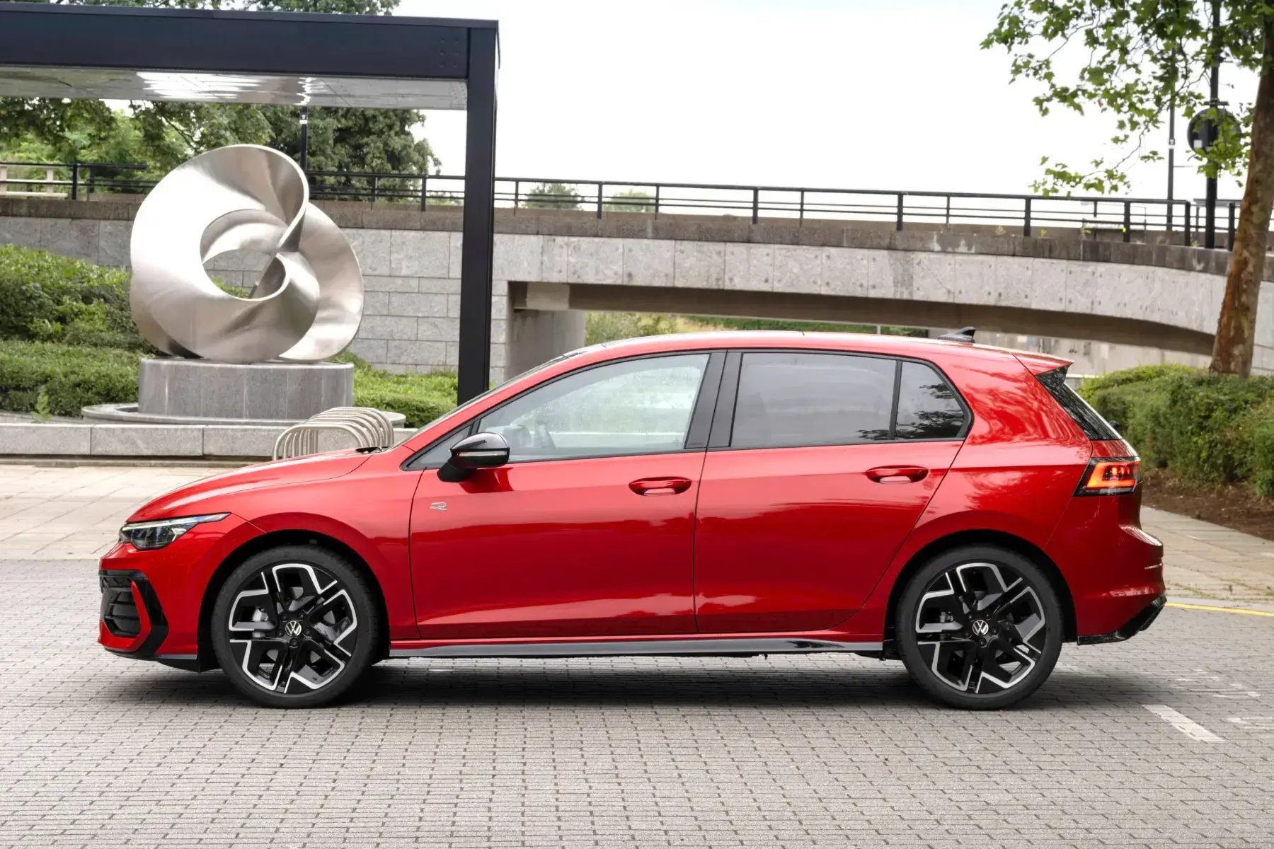 red-Volkswagen-Golf-side-parked