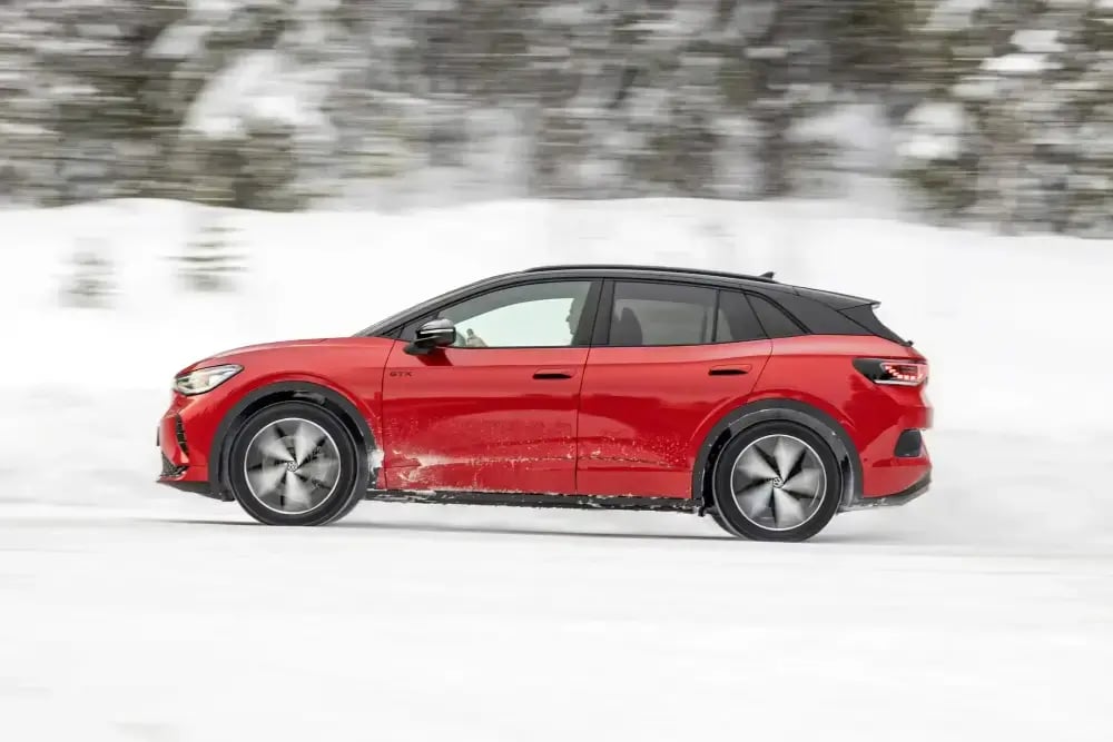 red-Volkswagen-ID.4-winter-driving-side