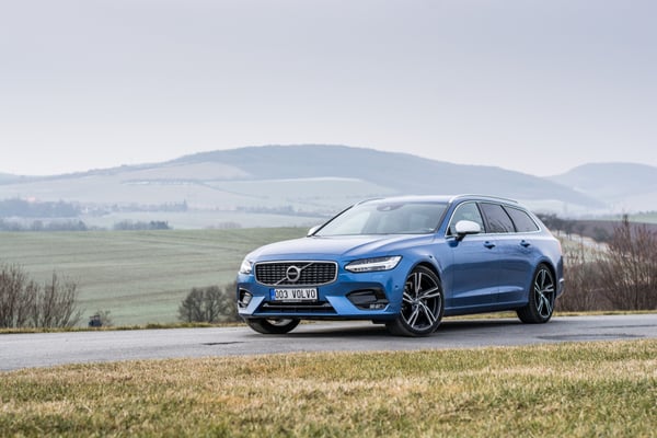 Blue Volvo V90 in the countryside