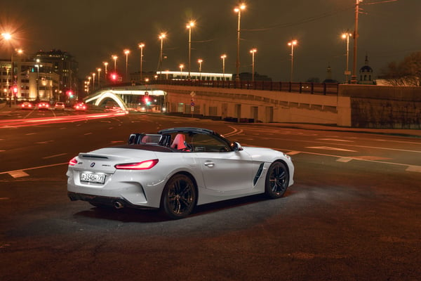 White BMW Z4 parked in a city with the roof down