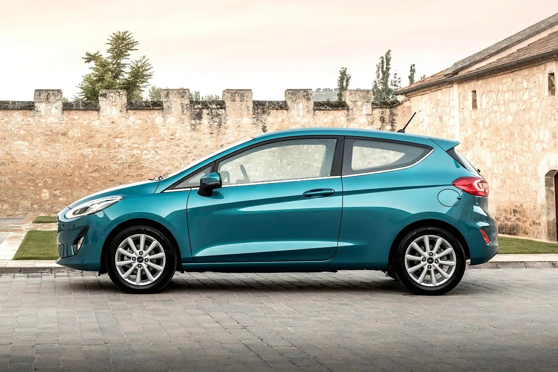 teal-Ford-Fiesta-parked-side