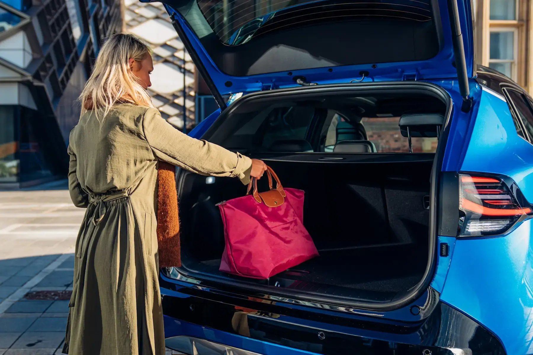 woman-putting-bag-car-boot